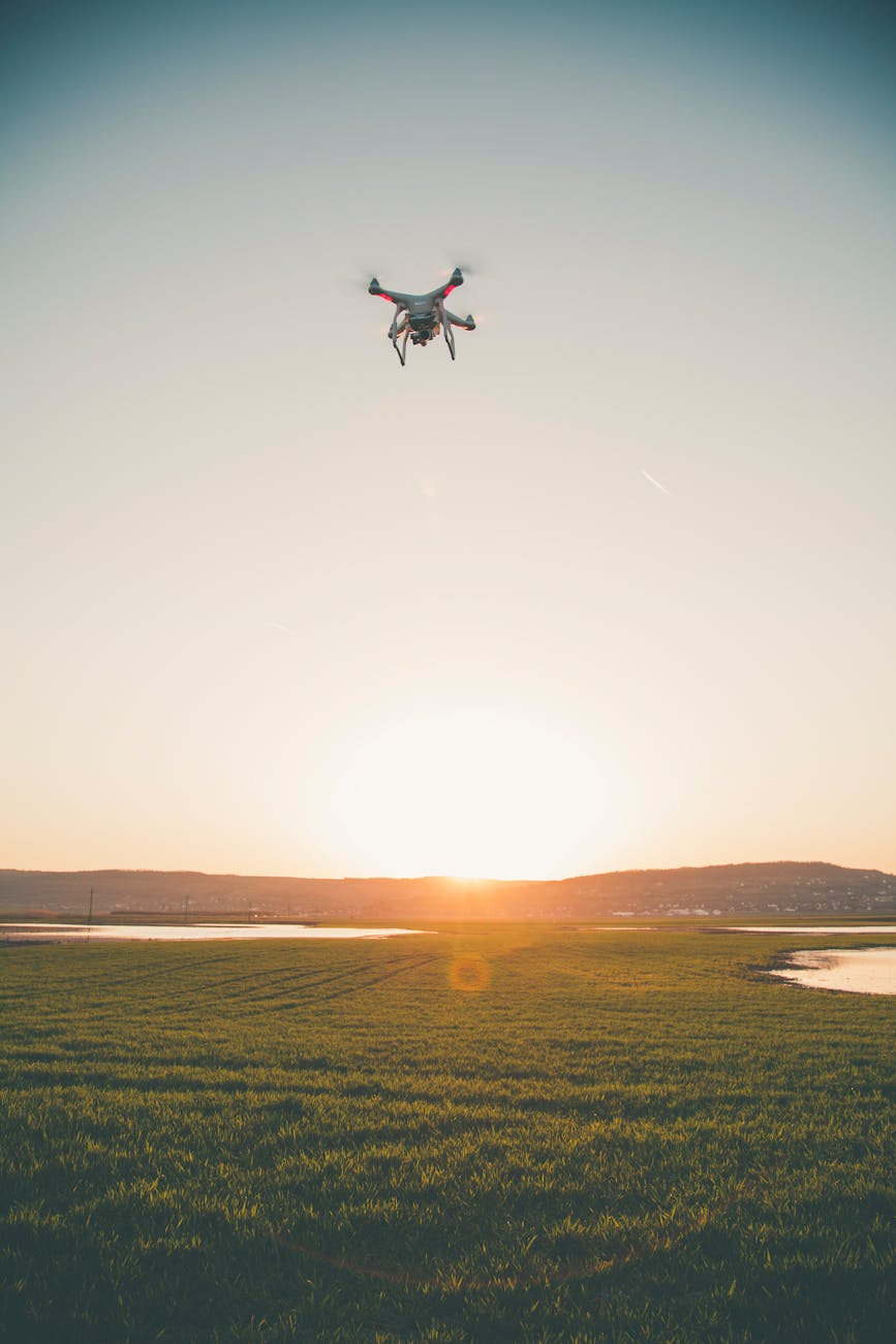photo of drone flying in the field